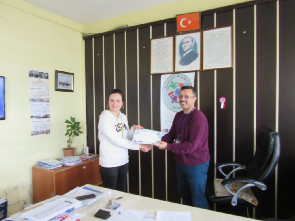70. Ali Çetinkaya Ortaokulu school’s headmaster giving the certificate to Turkish coordinator